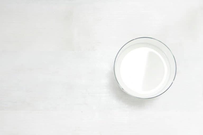 A glass of milk on a white table