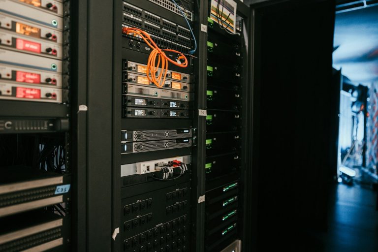 Racks of computer equipment with cabling inside a data room.
