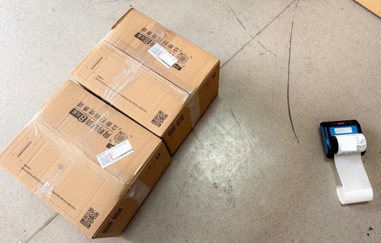 Two cardboard cartons sealed with tape and fitted with shipping labels.