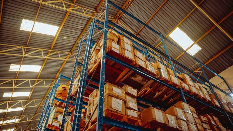 Metal storage racking holding stock in a well organised warehouse.