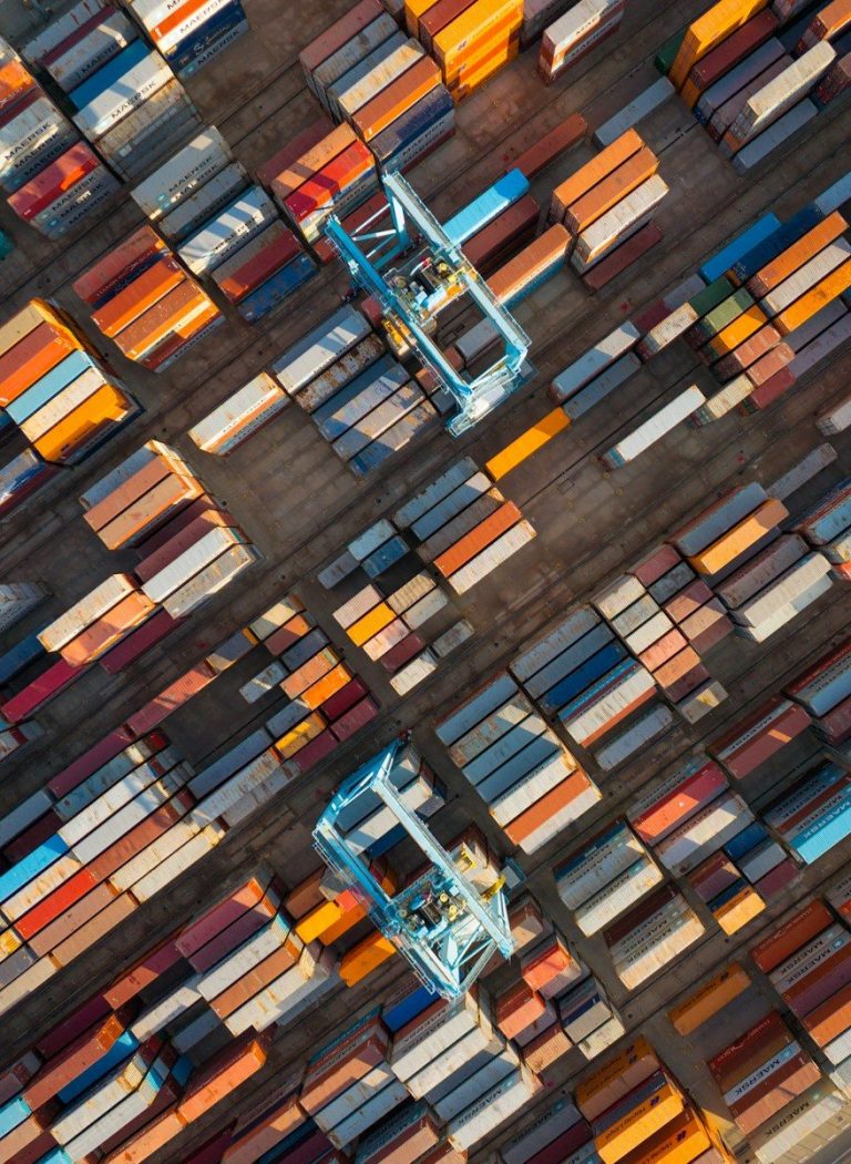 Aerial view of a shipping container yard with cranes