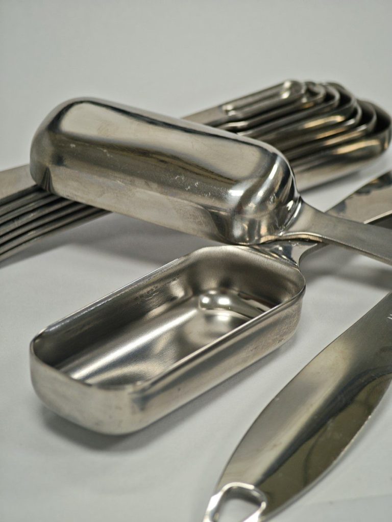 Smooth stainless steel trays and utensils with polished, seamless surfaces.