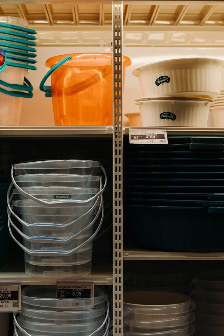 Storage shelves holding clean plastic containers and buckets kept off the floor.