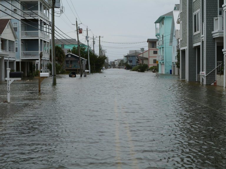 Flooded residential street with water covering the road